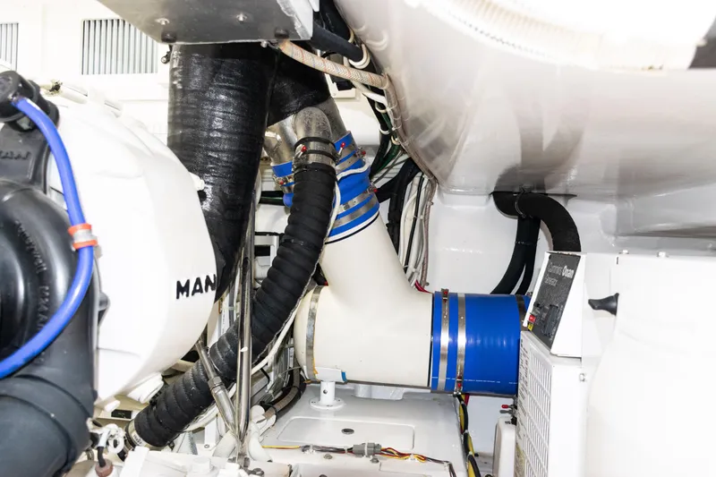Slide: The Image of Engine room of 2021 Viking 44 Open yacht with MAN components and blue hoses. - 88
