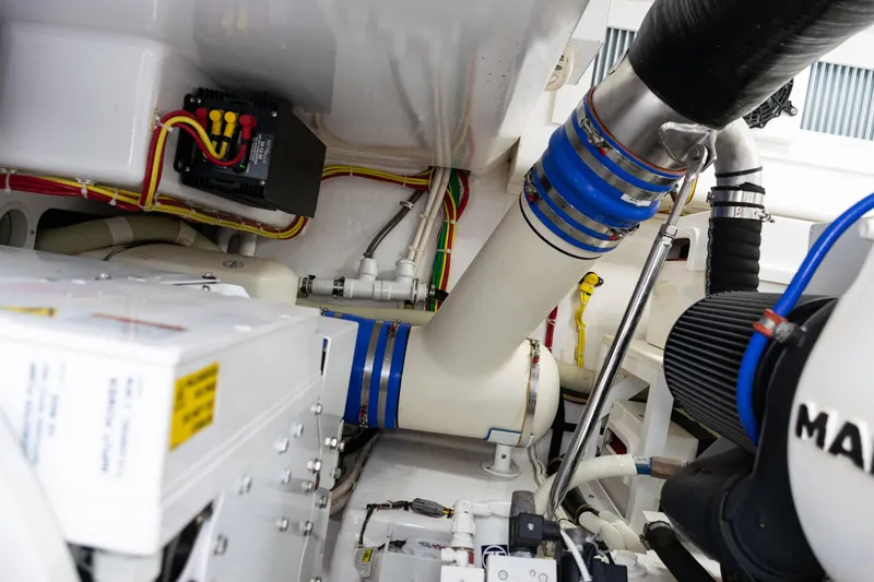 Slide: The Image of Engine room of 2021 Viking 44 Open yacht, showcasing mechanical components and wiring. - 89