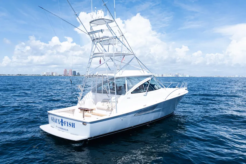 Slide: The Image of 2021 Viking 44 Open yacht on open sea under clear blue sky. - 99