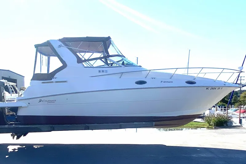 Slide: The Image of 2003 Cruisers Yachts 2870 Express boat on trailer under clear blue sky. - 1
