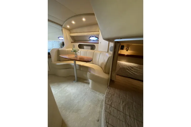 Slide: The Image of 2003 Cruisers Yachts 2870 Express interior with cozy seating and elegant table setting. - 13