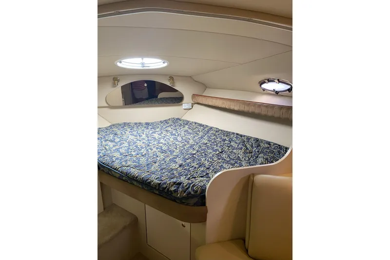 Slide: The Image of Interior cabin of 2003 Cruisers Yachts 2870 Express with patterned bedding. - 16