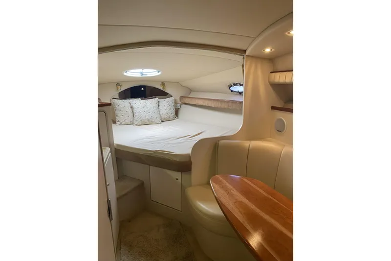 Slide: The Image of 2003 Cruisers Yachts 2870 Express cabin interior with bed and seating area. - 18