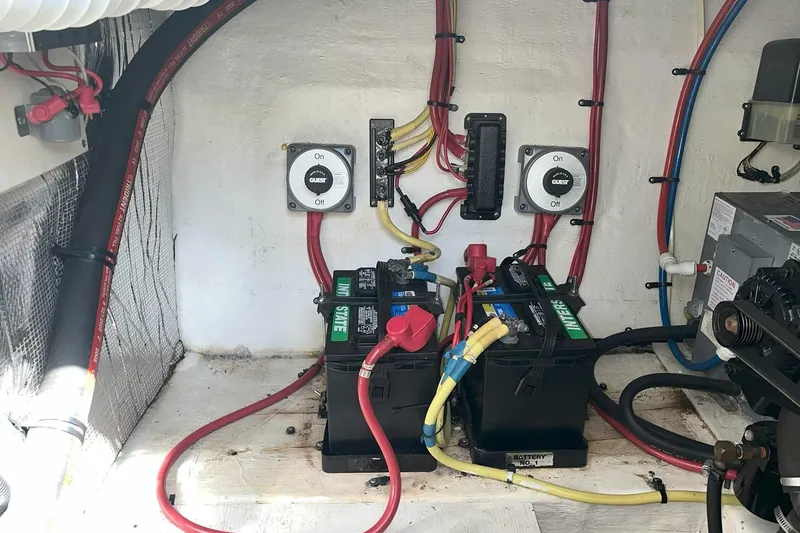 Slide: The Image of 2003 Cruisers Yachts 2870 Express engine compartment with batteries and wiring setup. - 29