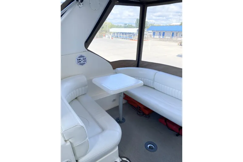 Slide: The Image of 2003 Cruisers Yachts 2870 Express interior with white seating and table. - 6