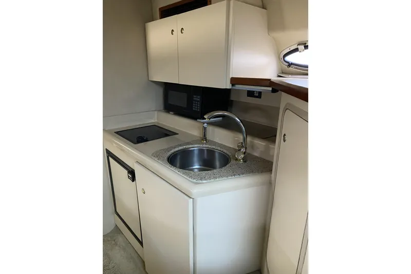 Slide: The Image of 2003 Cruisers Yachts 2870 Express kitchen with sink, stove, and microwave. - 20