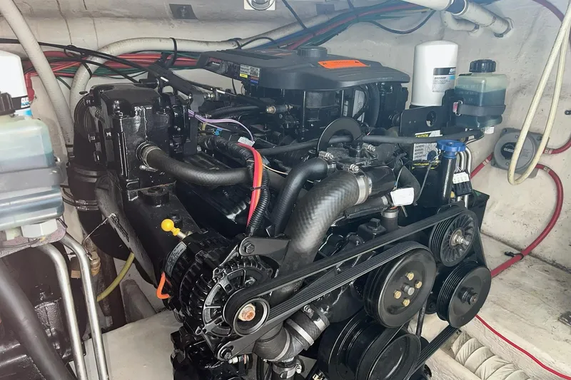 Slide: The Image of Engine compartment of a 2003 Cruisers Yachts 2870 Express, showcasing detailed mechanical components. - 22
