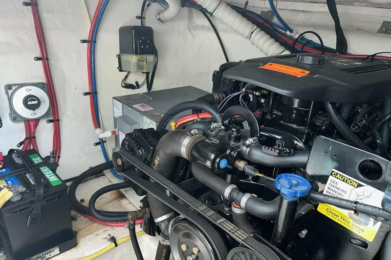 Slide: The Image of Engine compartment of a 2003 Cruisers Yachts 2870 Express, showing detailed mechanical components. - 25