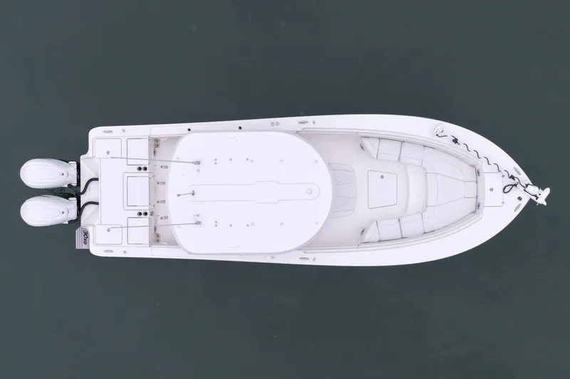 Slide: The Image of Aerial view of 2025 Regulator 30XO boat with dual engines on calm water. - 16