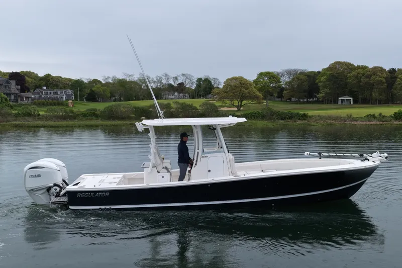 The Image of 2025 Regulator 30XO boat on calm water, featuring Yamaha engine, scenic background. - 0