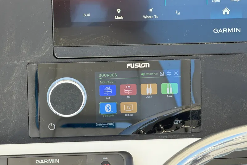 Slide: The Image of 2025 Regulator 30XO boat dashboard with Garmin and Fusion MS-RA770 audio system. - 39