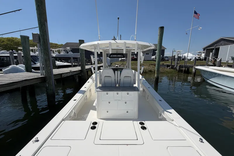 Slide: The Image of 2025 Regulator 30XO boat docked at marina under clear blue sky. - 22