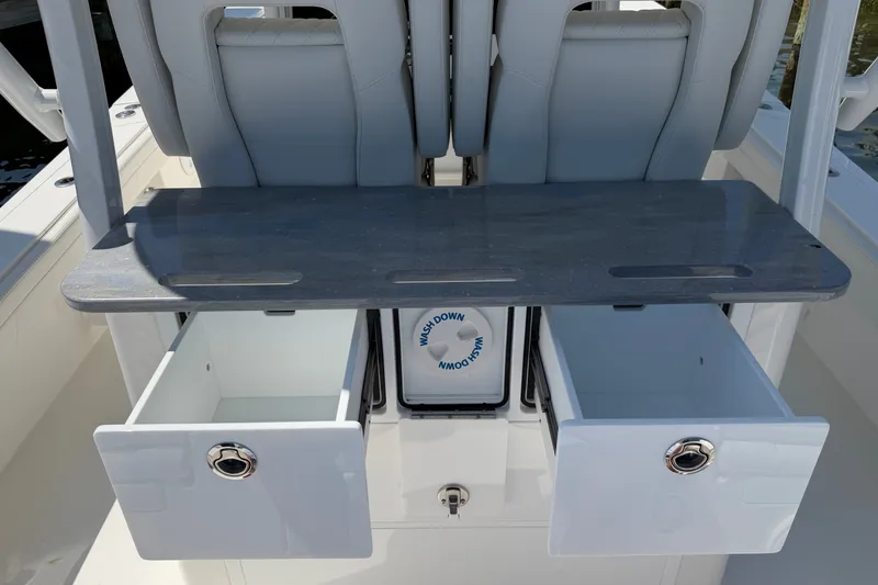 Slide: The Image of 2025 Regulator 30XO boat interior with open storage drawers and seating. - 28