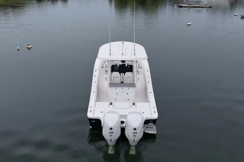 Slide: The Image of 2025 Regulator 30XO boat with twin engines on calm water. - 15