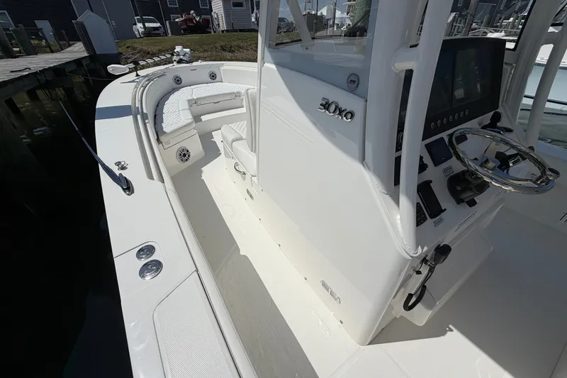 Slide: The Image of 2025 Regulator 30XO boat interior with helm, seating, and control panel. - 47
