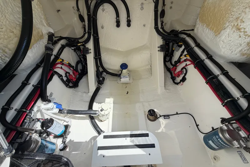 Slide: The Image of Interior view of 2025 Regulator 30XO boat's engine compartment with wiring and components. - 21