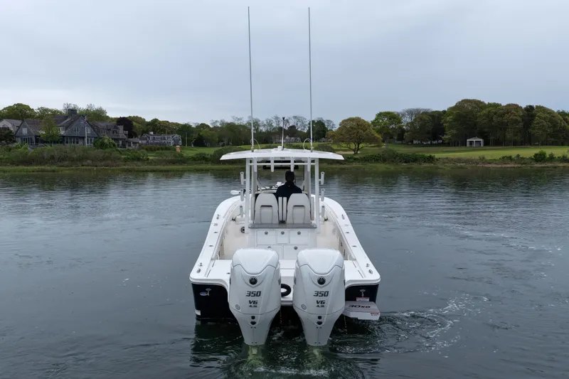 Slide: The Image of 2025 Regulator 30XO boat with dual 350 V6 engines on a calm waterway. - 9
