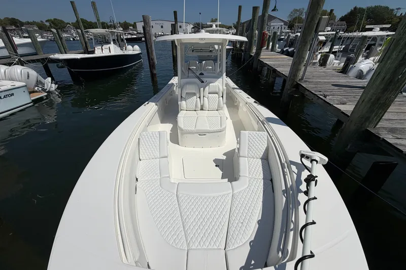 Slide: The Image of 2025 Regulator 30XO boat docked, featuring spacious seating and modern design. - 50