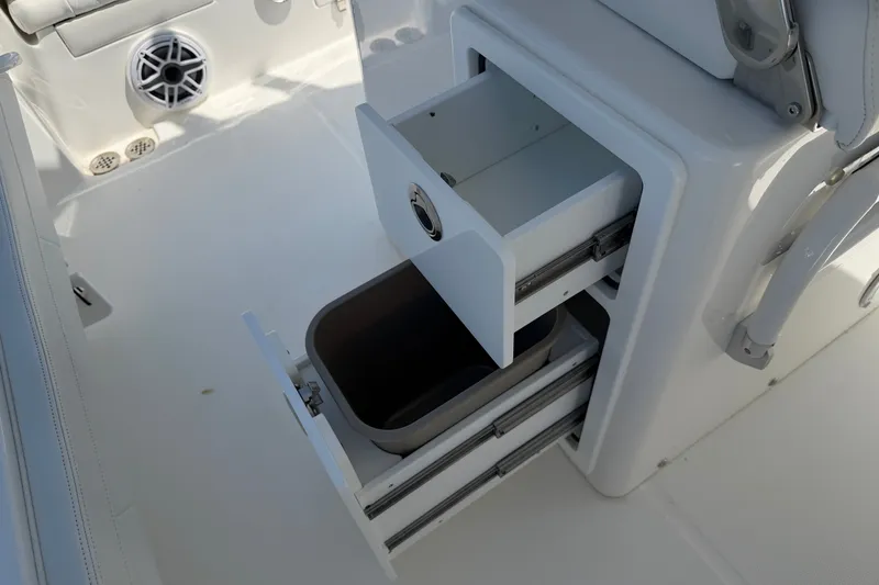 Slide: The Image of 2025 Regulator 30XO boat interior with open storage compartments and sleek design. - 29