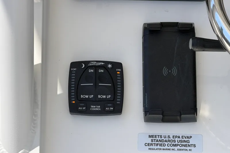 Slide: The Image of Control panel of a 2025 Regulator 30XO boat with trim tab controls. - 38