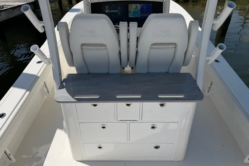 Slide: The Image of 2025 Regulator 30XO boat interior with dual seats and storage compartments. - 25