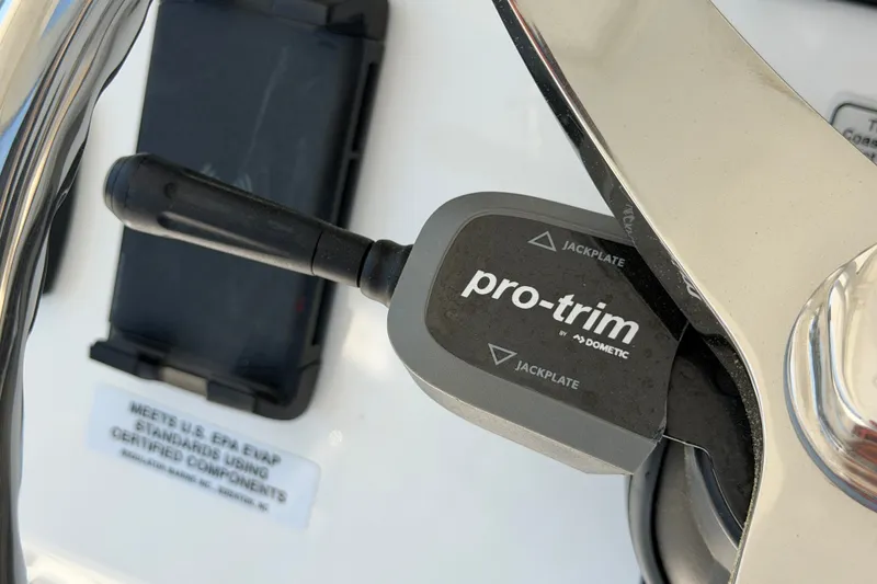 Slide: The Image of Close-up of Pro-Trim control on 2025 Regulator 30XO boat dashboard. - 40