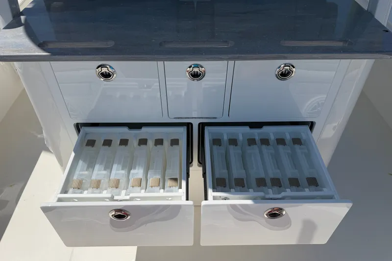 Slide: The Image of 2025 Regulator 30XO boat storage drawers with organized compartments and sleek design. - 27