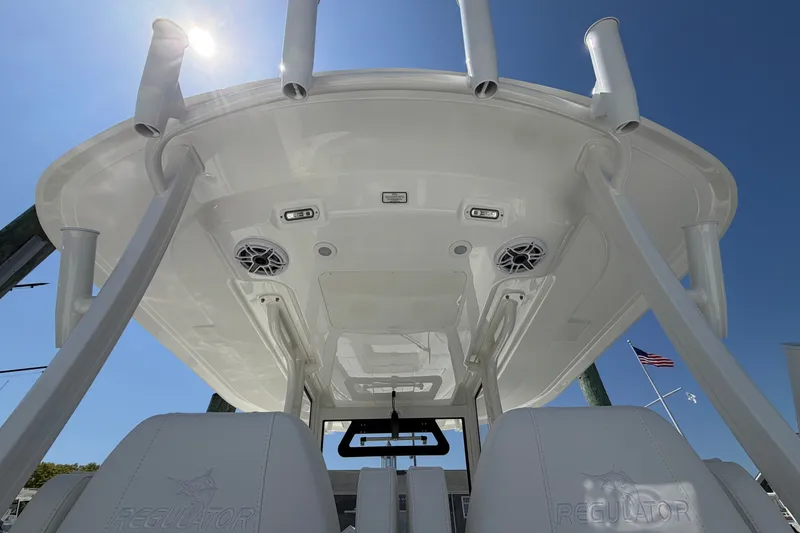 Slide: The Image of 2025 Regulator 30XO boat interior, featuring sleek design and integrated speakers under a sunny sky. - 24
