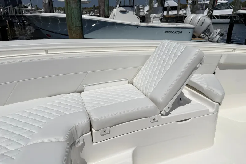 Slide: The Image of Luxurious seating on 2025 Regulator 30XO boat, featuring white quilted upholstery. - 53