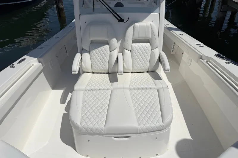 Slide: The Image of Luxurious seating on 2025 Regulator 30XO boat, featuring white quilted upholstery. - 57