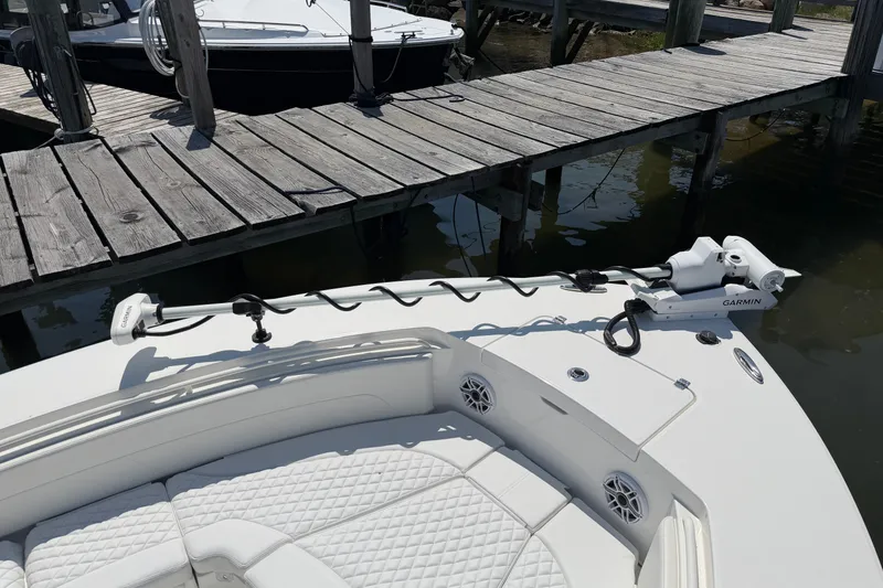 Slide: The Image of 2025 Regulator 30XO boat with Garmin equipment docked at a wooden pier. - 54
