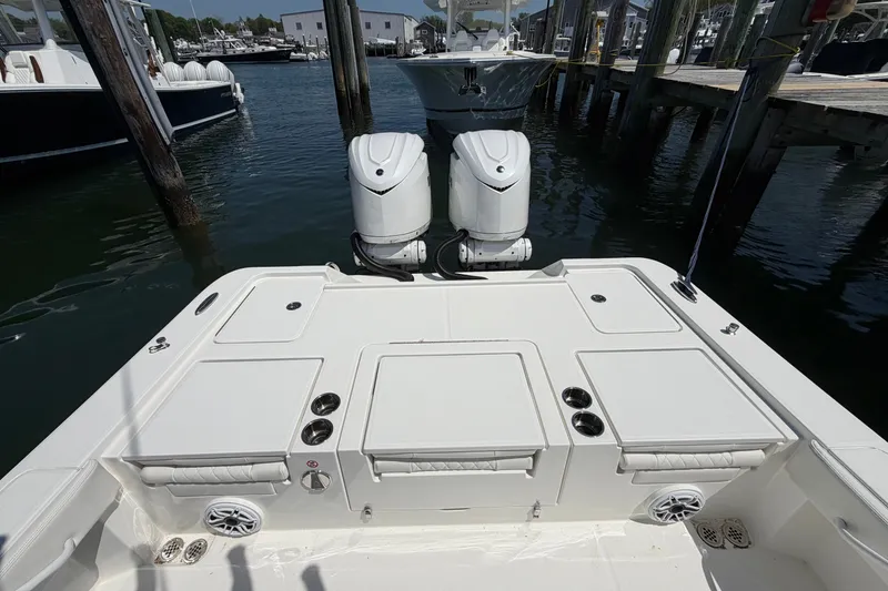Slide: The Image of 2025 Regulator 30XO boat with dual outboard motors docked at marina. - 18