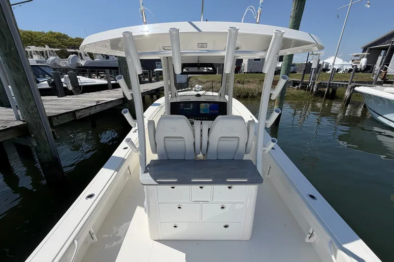 Slide: The Image of 2025 Regulator 30XO boat interior with dual seats and control panel at dock. - 23