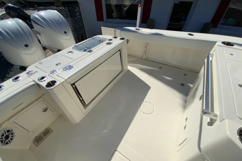 Slide: The Image of 2025 Cobia 285 Open Center Console boat interior with storage and dual engines. - 15