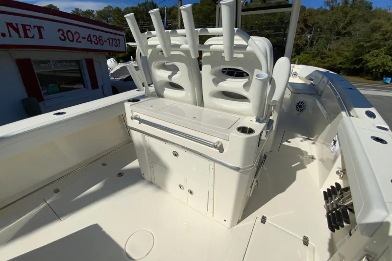 Slide: The Image of 2025 Cobia 285 Open Center Console boat interior with rod holders and storage compartments. - 19