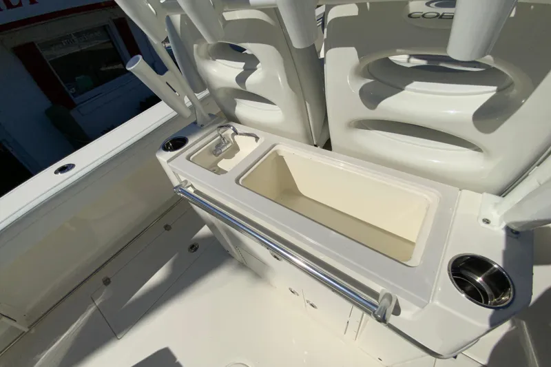 Slide: The Image of 2025 Cobia 285 Open Center Console boat interior with sink and storage. - 20