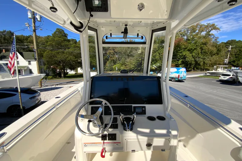 Slide: The Image of 2025 Cobia 285 Open Center Console boat interior with steering wheel and dashboard. - 25