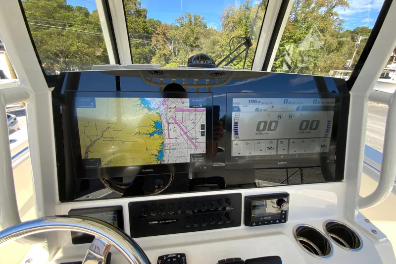 Slide: The Image of 2025 Cobia 285 Open Center Console dashboard with Garmin navigation and control displays. - 26