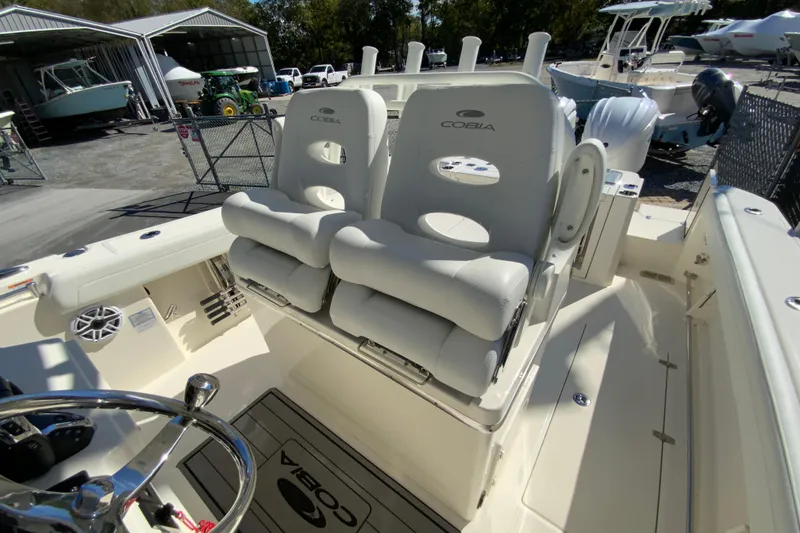 Slide: The Image of 2025 Cobia 285 Open Center Console boat interior with dual seating and steering wheel. - 29
