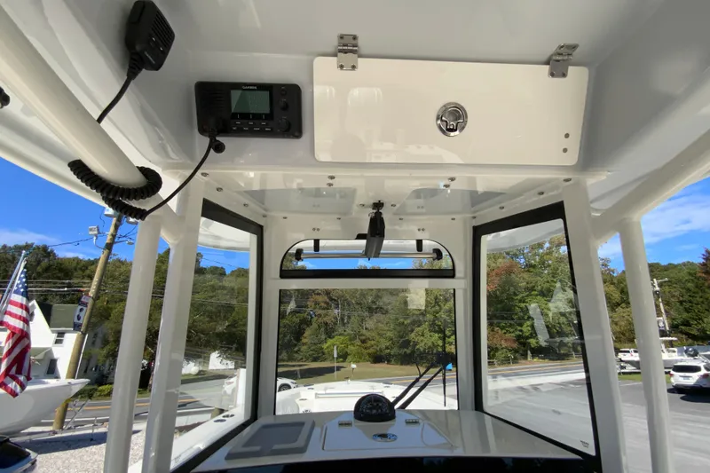 Slide: The Image of 2025 Cobia 285 Open Center Console interior with navigation equipment and clear view. - 31