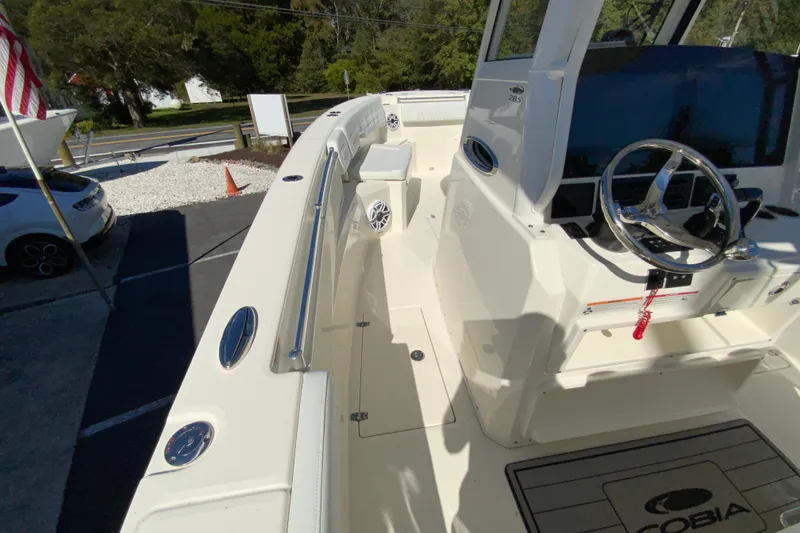 Slide: The Image of 2025 Cobia 285 Open Center Console boat interior with steering wheel and seating. - 33