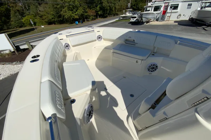 Slide: The Image of 2025 Cobia 285 Open Center Console boat interior with seating and speakers. - 34