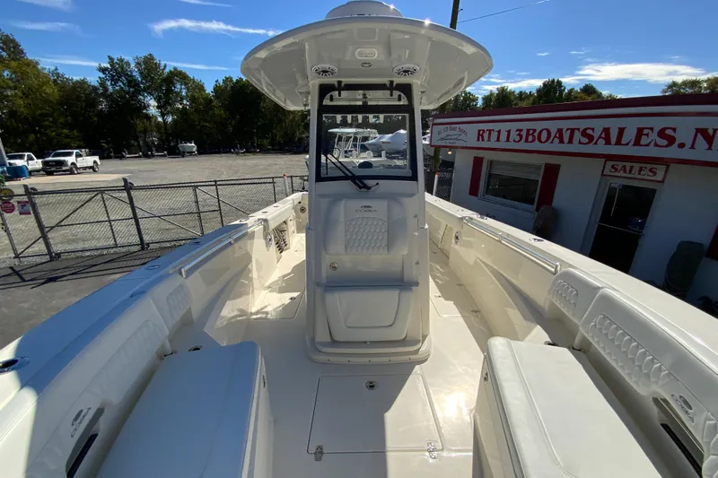 Slide: The Image of 2025 Cobia 285 Open Center Console boat at dealership, showcasing spacious deck and seating. - 37
