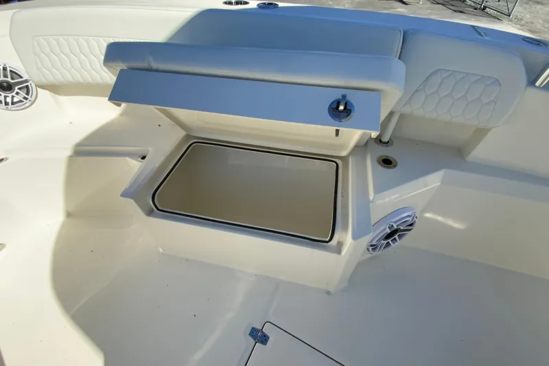 Slide: The Image of 2025 Cobia 285 Open Center Console boat with open storage compartment and speaker. - 38