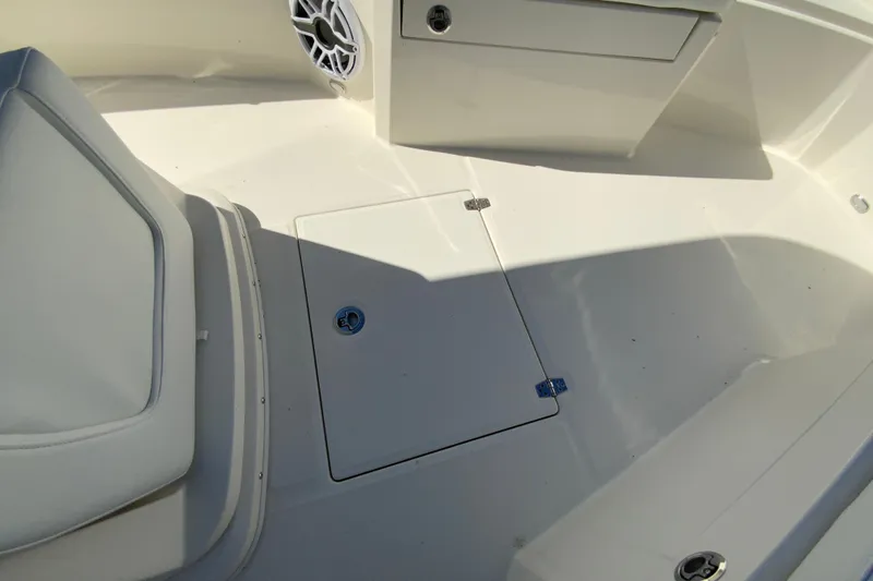 Slide: The Image of 2025 Cobia 285 Open Center Console boat interior with storage hatch and seating. - 39