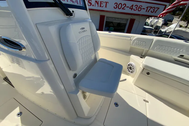 Slide: The Image of 2025 Cobia 285 Open Center Console boat interior with seating and speaker. - 45