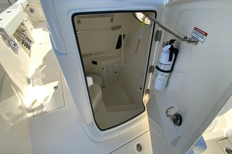 Slide: The Image of 2025 Cobia 285 Open Center Console interior with storage and safety equipment. - 46