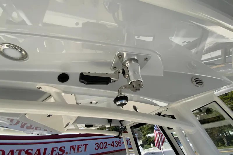 Slide: The Image of 2025 Cobia 285 Open Center Console boat interior with fishing rod holder. - 50