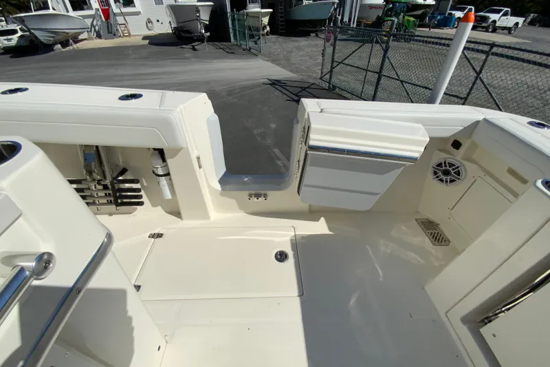 Slide: The Image of 2025 Cobia 285 Open Center Console boat interior with storage and seating features. - 52