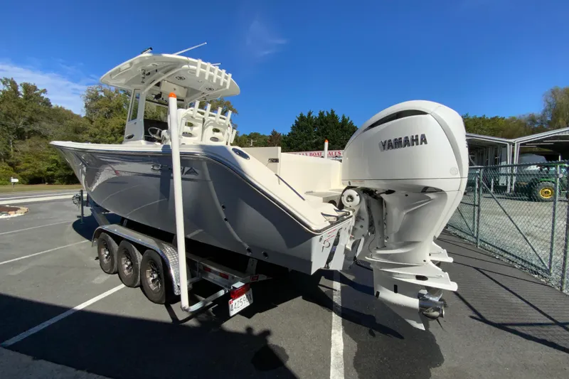 Slide: The Image of 2025 Cobia 285 Open Center Console boat with Yamaha engine on trailer. - 8